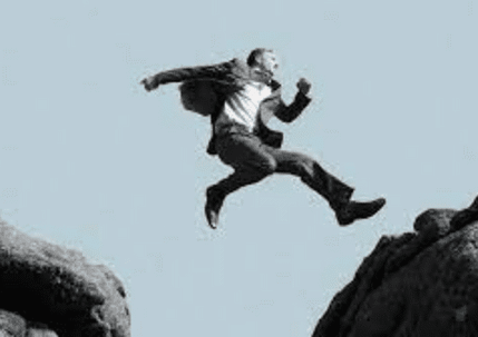 A man leaps between two rock