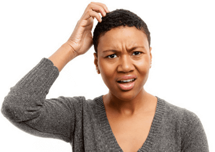 A woman scratches her head