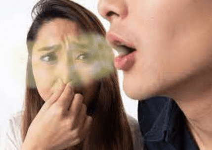 A man exhales towards a disgusted woman
